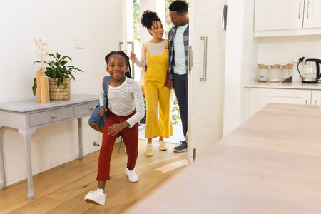 Happy african american family coming home, copy space. Expression, togetherness, parenthood, childhood and domestic life, unaltered.の写真素材