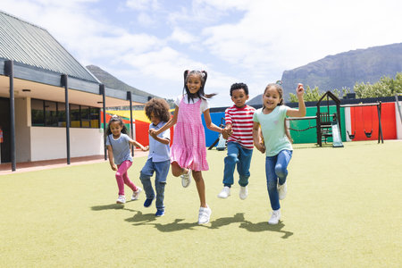 In school, group of young students are running outside. They have diverse ethnicities and are wearing casual clothes, unalteredの写真素材