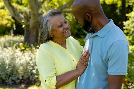 Smiling senior couple enjoying conversation and bonding in outdoor park. Friendship, retirement, elderly, leisure, happiness, companionshipの写真素材