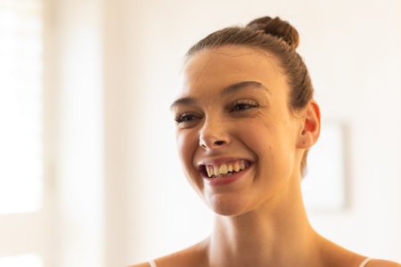 Smiling young woman at home, enjoying bright and cheerful moment. Happiness, indoors, lifestyle, relaxation, cozy, positiveの写真素材