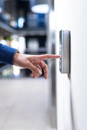 Pressing button on security keypad, person entering office building. access, control, entry, automation, technology, businessの写真素材