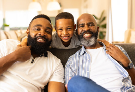 Smiling family sitting on couch, child hugging two adults, enjoying time together. togetherness,...