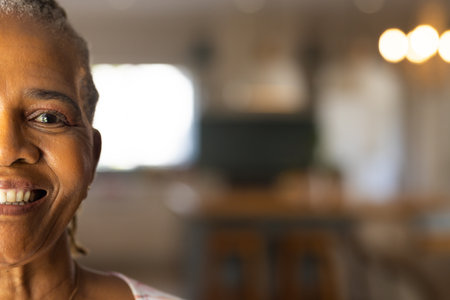 "Smiling elderly woman at home, showing happiness and contentment, copy space. Senior, wellness, lifestyle, positivity, relaxationの写真素材