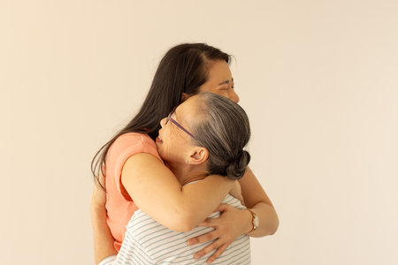 "Hugging each other, asian grandmother and granddaughter sharing warm embrace. family, affection, bonding, intergenerational, togetherness, supportの写真素材