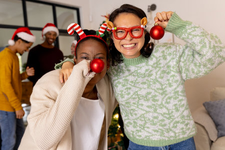 Celebrating Christmas at home, multiracial friends wearing festive accessories and smiling together....