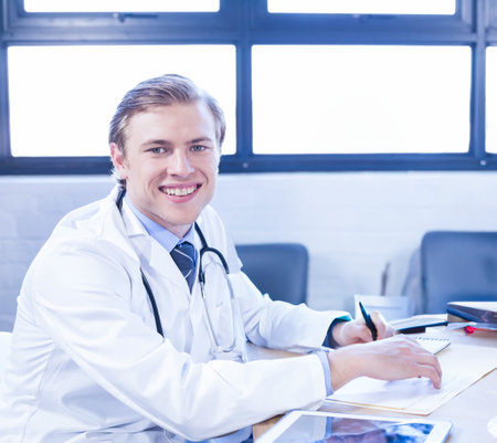 Portrait of young doctor smiling at conference roomの写真素材