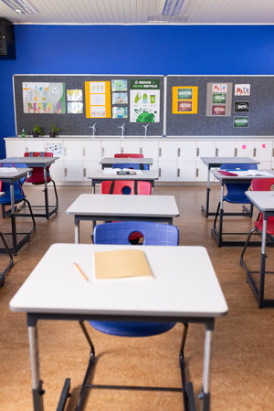 Empty classroom with desks and chairs, ready for students to arrive, copy space. Education,...