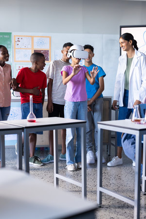 Using VR headset, student engaging in virtual experiment in school classroom. Education, virtual...