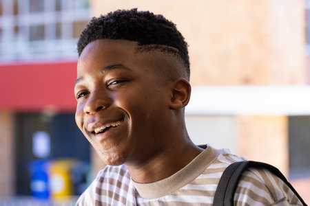 Smiling student with backpack enjoying time outside school building. Education, back to school, learning, outdoors, happiness, teenagerの写真素材