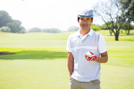 Golfing friends smiling at camera at the golf courseの写真素材