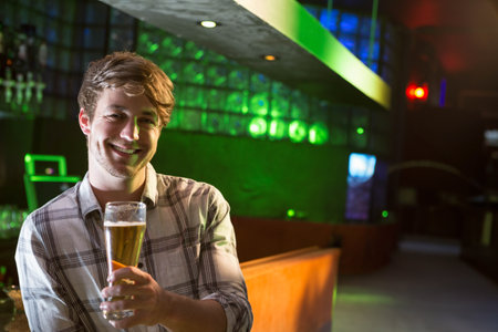 Portrait of two men having beer at bar counter in bar