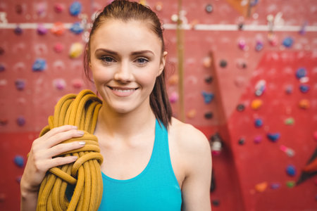 Fit woman at the rock climbing wall at the gymの写真素材