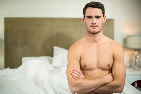 Upset man having an argument in the bedroomの写真素材