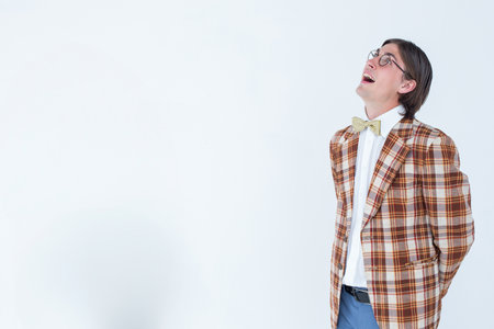 Man standing clasping hands behind back in studio wearing blazer and bow tie, copy space. Portrait, professional, fashion, minimalistic, style, confidence, eleganceの写真素材
