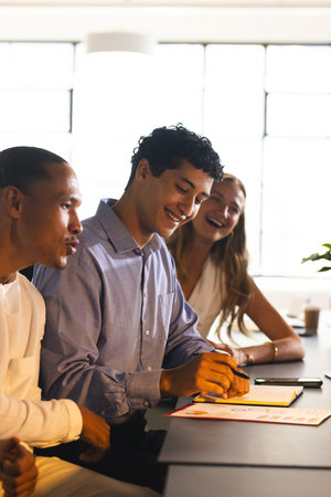 Colleagues collaborating at office, smiling and discussing ideas during meeting. Teamwork, business, brainstorming, strategy, communication, corporateの写真素材