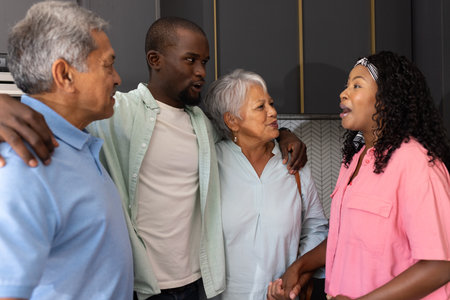 Family gathering at home, multigenerational members smiling and talking together. togetherness, celebration, bonding, relatives, happinessの写真素材