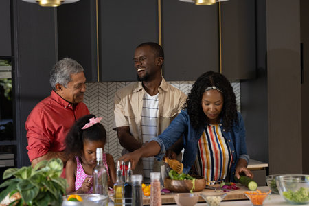 In kitchen, multigenerational family cooking and sharing laughter while preparing meal. togetherness, bonding, culinary, happiness, generations, joyの写真素材