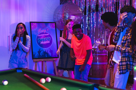 Teens enjoying disco-themed birthday party with laughter and vibrant decorations. celebration, teenagers, fun, dance, friendship, musicの写真素材