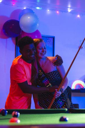Teenagers celebrating birthday playing pool, smiling and enjoying party atmosphere. celebration, billiards, fun, friendship, leisure, happinessの写真素材