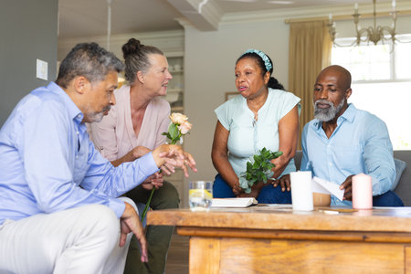 Seniors at home discussing while holding flowers, enjoying friendly conversation. Elderly, friendship, discussion, companionshipの写真素材