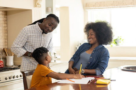 Family enjoying quality time at home, child drawing while parents happily watching. bonding, happiness, parenting, creativity, leisure, childhoodの写真素材