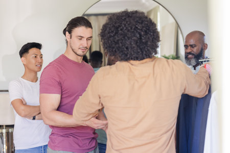 Groom and friends selecting outfits, preparing for wedding day celebration. fashion, friendship, attire, event, formal, getting readyの写真素材