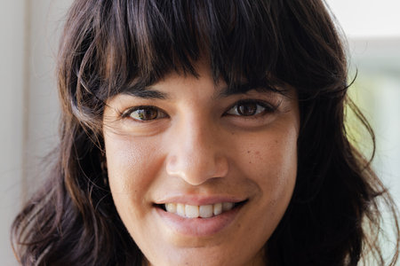 Smiling woman with dark hair looking at camera, showing happiness. portrait, cheerful, expression,...