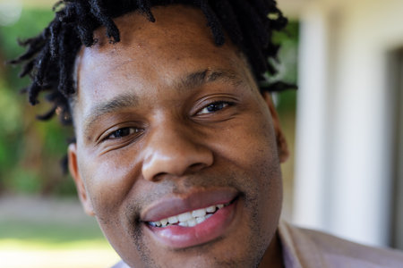 Man with friends outdoors, smiling and enjoying sunny day together. Friendship, leisure, happiness, nature, summerの写真素材