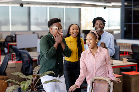 Celebrating success, team in office smiling and expressing excitement together. Teamwork, achievement, collaboration, business, corporate, celebrationの写真素材
