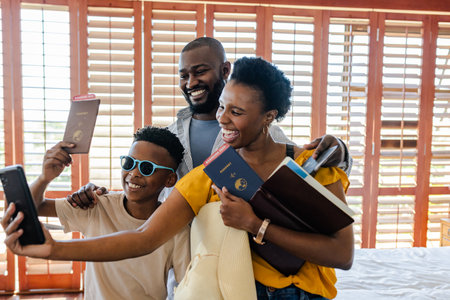 Family taking selfie with passports, smiling and preparing for vacation adventure. Travel, journeyの写真素材