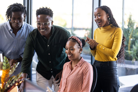 Team collaborating on project, smiling and discussing ideas in modern office. Collaboration, teamwork, brainstorming, creative, discussion, innovationの写真素材