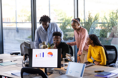 Collaborating on project, African American team using laptops and charts in office. Teamwork, collaboration, technology, brainstorming, diversity, businessの写真素材