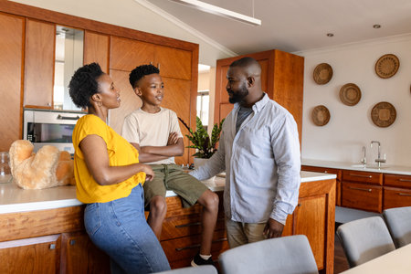 Family enjoying conversation in modern kitchen, sharing smiles and connection. bonding, happiness, togetherness, communication, relationship, lifestyleの写真素材