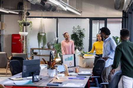 Diverse team collaborating in modern office, discussing project with enthusiasm. Teamwork,...