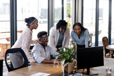 Collaborating on project, African American team discussing ideas and smiling at office. Teamwork, brainstorming, collaboration, discussion, diversity, businessの写真素材