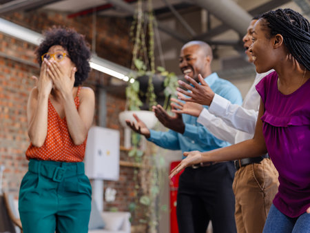 Celebrating success, African American colleagues expressing excitement and joy in office. Teamwork, collaboration, achievement, business, victory, diversityの写真素材
