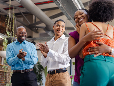 Colleagues celebrating success with smiles and applause in modern office setting. Teamwork, collaboration, achievement, celebration, corporate, happinessの写真素材