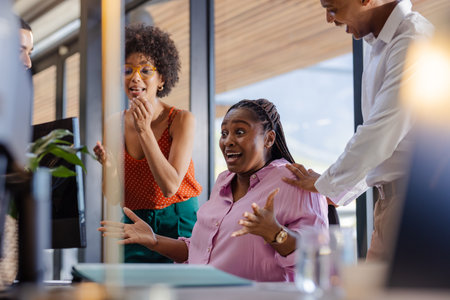 In office, colleagues celebrating success, showing joy and enthusiasm together. Teamwork, celebration, collaboration, business, achievementの写真素材