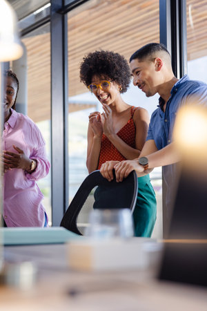 Colleagues in office discussing project, smiling and collaborating on ideas. Teamwork, brainstorming, meeting, collaboration, innovation, corporateの写真素材