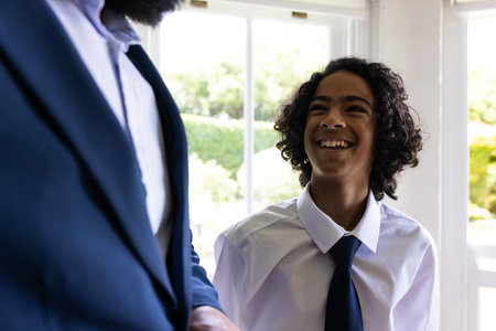 Young boy in formal attire smiling joyfully during bar mitzvah indoors. Ceremony, tradition, happiness, childhood, faith, eventの写真素材