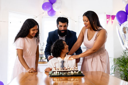 Celebrating birthday, family with cake and festive decorations, smiling at home. Celebration,...