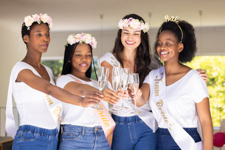 Celebrating friendship, diverse women toasting with champagne at bridal party. celebration, diversity, happinessの写真素材