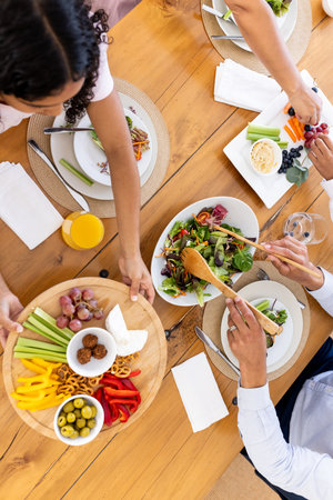 Sharing vibrant vegetarian meal with friends, enjoying fresh salads and appetizers. healthy, lifestyleの写真素材