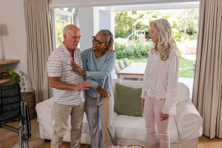 Senior friends sharing joyful conversation and laughter at home, enjoying moments together. Friendship, happiness, gathering, lifestyle, elderly, funの写真素材