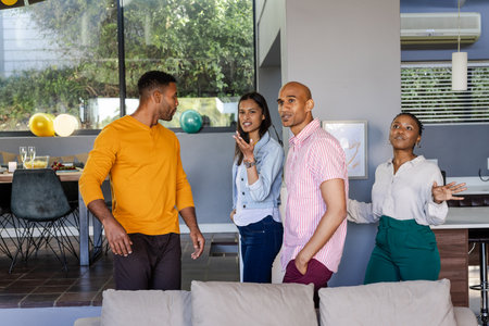 Chatting and laughing, friends enjoying casual gathering at home together. Friendship, togetherness,...