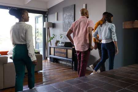 Friends exploring modern living room, enjoying time together at home. Friendship, togetherness, leisure, relaxation, lifestyle, bondingの写真素材