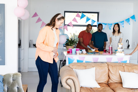Friends celebrating at home with snacks and decorations, enjoying festive atmosphere. Celebration,...