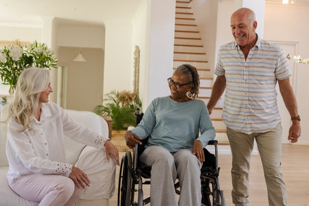 Senior friends enjoying conversation at home, smiling and sharing joyful moments. indoor activities,...
