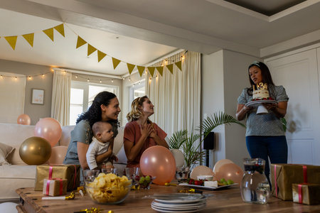 Family celebrating birthday at home with cake and decorations, feeling joyful. Celebration, family time, happiness, party, gathering, funの写真素材