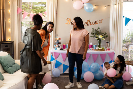 Celebrating baby shower, women with balloons and cake, sharing joyful moments together. Celebration, party, dessert, friendship, maternityの写真素材